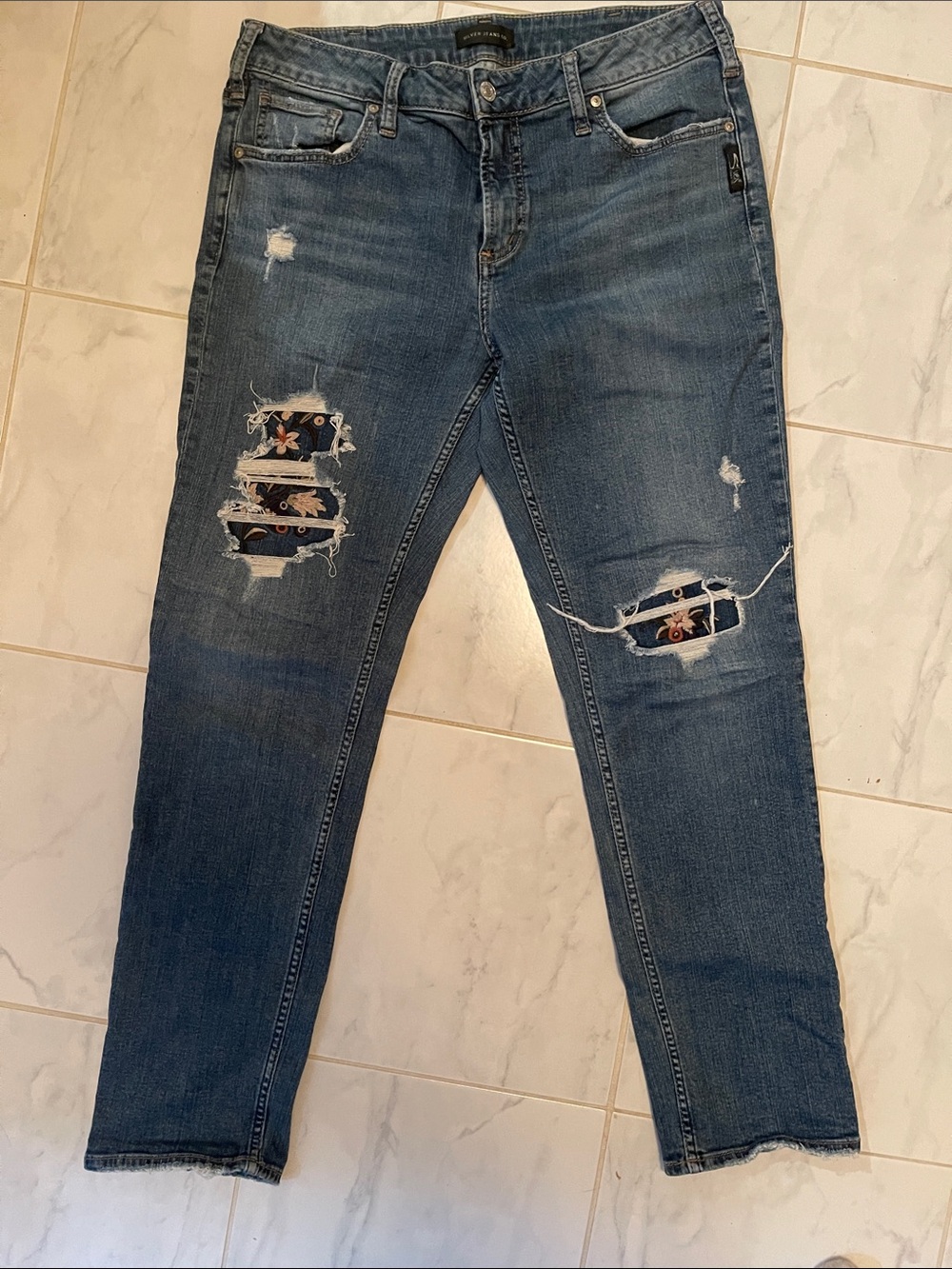 Silver Jeans Dark Blue Distressed Slim with Floral Patches.